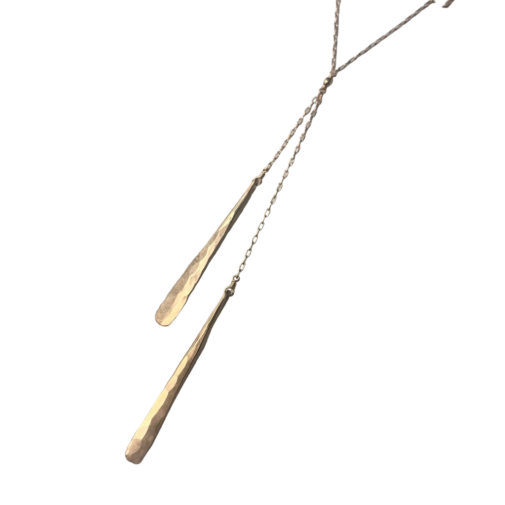 Gold necklace with a chain on a white background