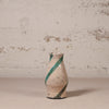 Ceramic vase with green stripes on a textured surface and background