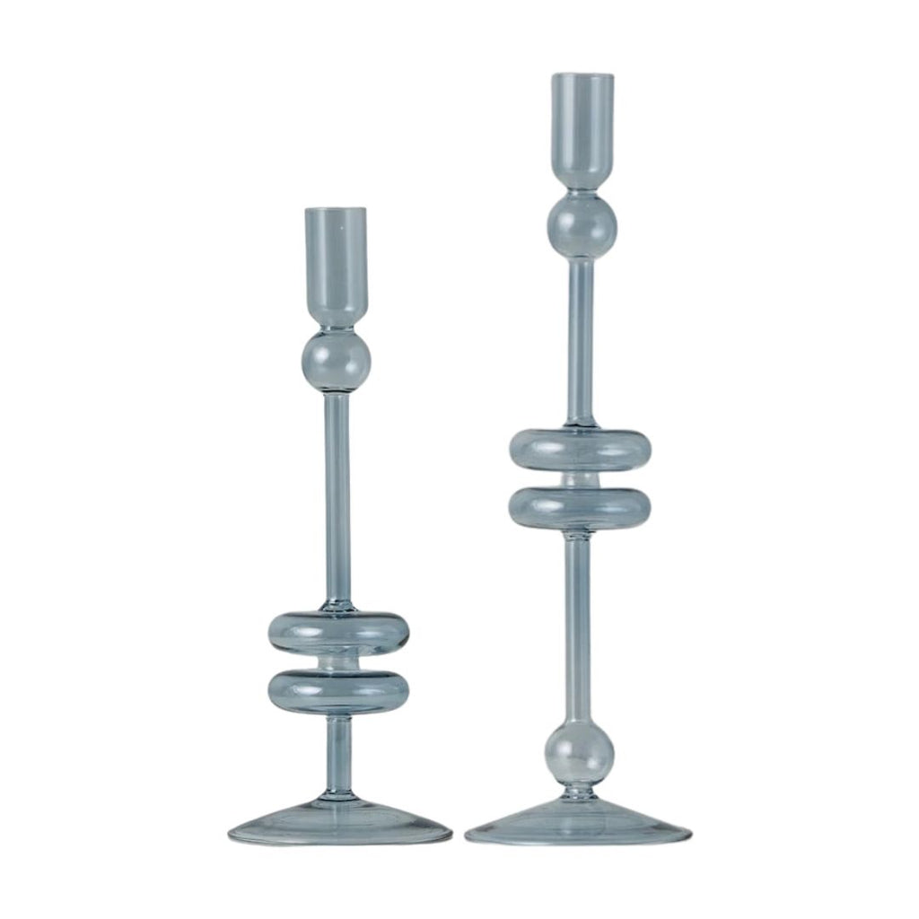 Two light blue glass candle holders on a white background
