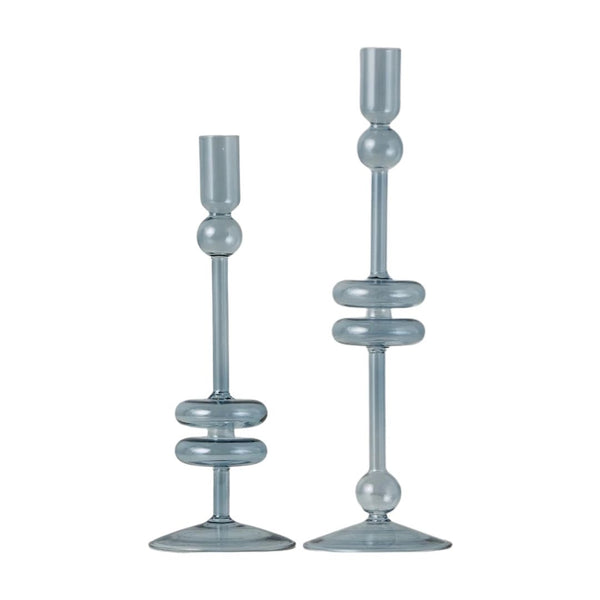 Two light blue glass candle holders on a white background