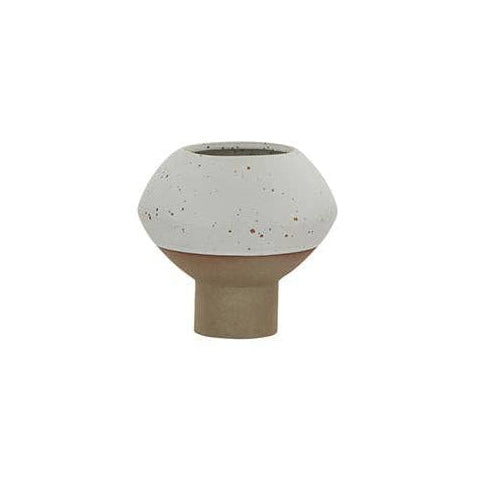 A small ceramic bud vase with a speckled off-white top and a matte tan base, centered on a solid white background.