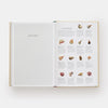 Open book showing a glossary with illustrations of Italian ingredients on a white background