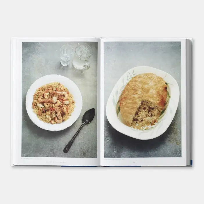 Open book showing two plates of food on a gray surface
