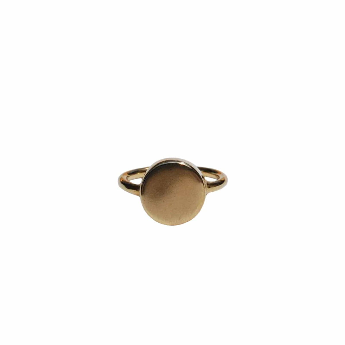 Gold ring with a circular design on a light gray background