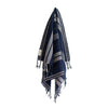 Navy and gray striped towel with tassels on a white background