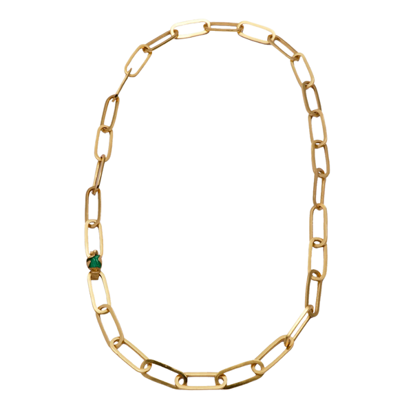A gold chain necklace with a single small green gemstone accent, displayed on a clean white background.