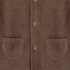 Close-up of a brown cardigan with button details and two pockets.