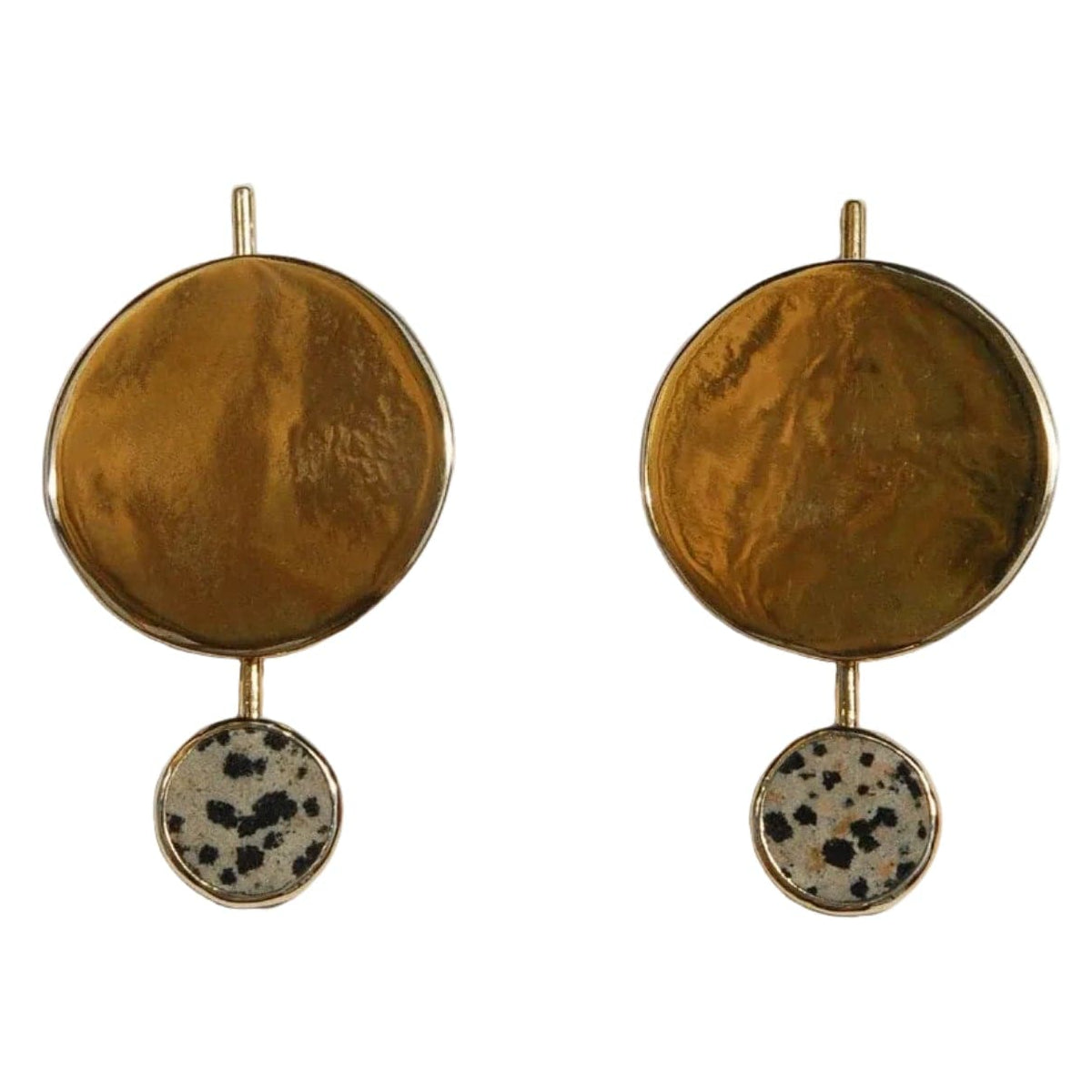 Pair of brass earrings with round top and spotted bottom on a white background