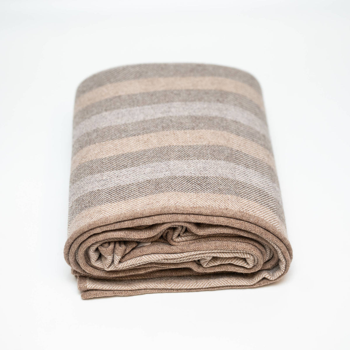 folded striped cashmere blanket on white background