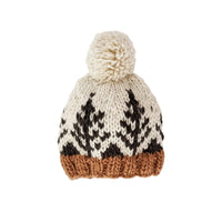 A hand-knit winter beanie with a cream-colored pom-pom, featuring a black geometric pattern on the upper half and a contrasting brown ribbed brim, shown against a plain white background.