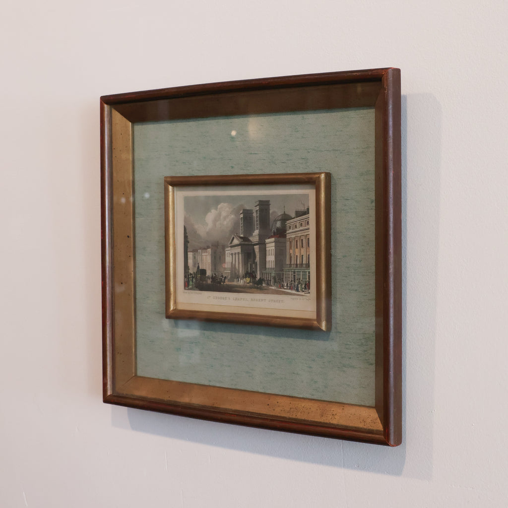 Framed artwork of a cityscape on a light gray wall