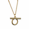 Gold necklace with a unique pendant on a white geometric background