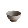 Ceramic bowl on a gray surface with a neutral background
