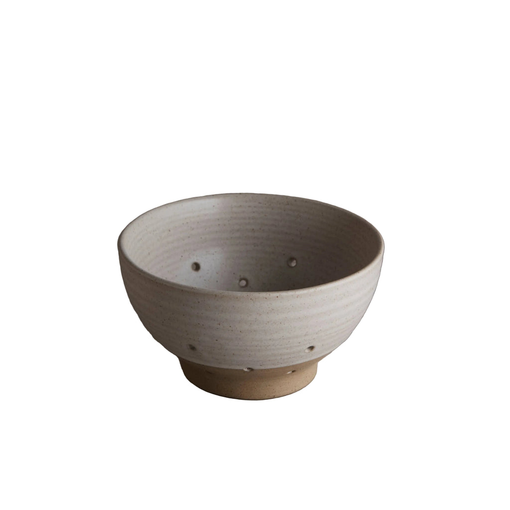 Ceramic bowl on a gray surface with a neutral background