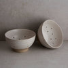 Two ceramic bowls on a neutral background