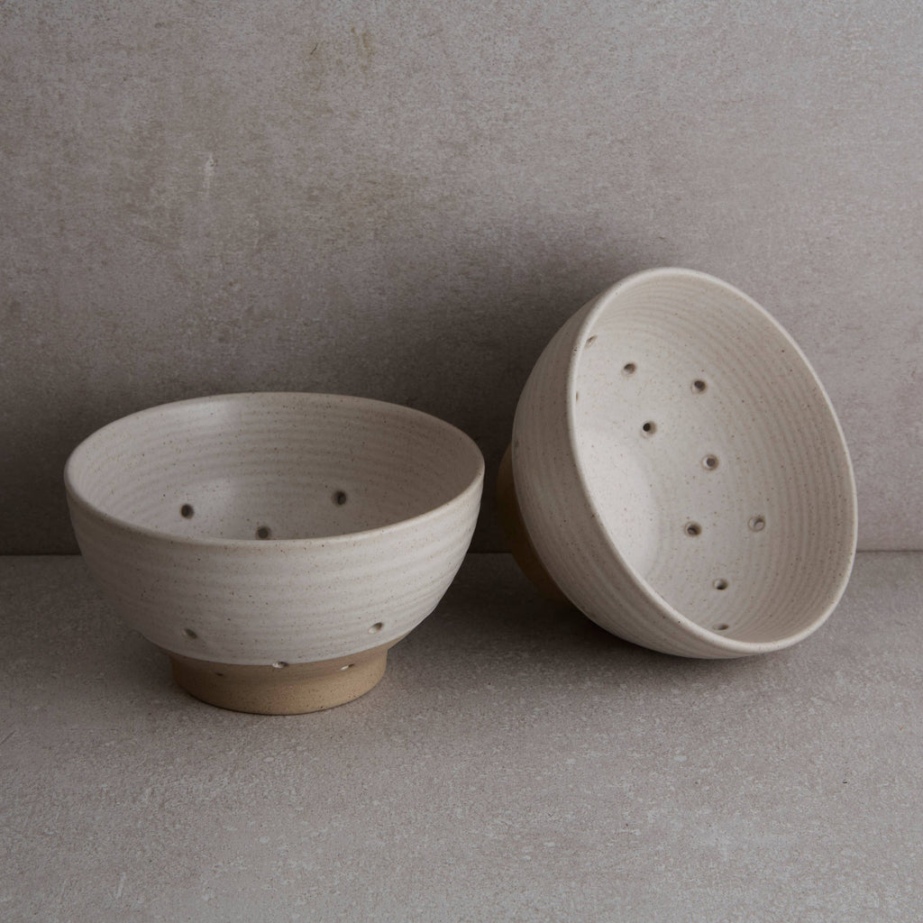 Two ceramic bowls on a neutral background