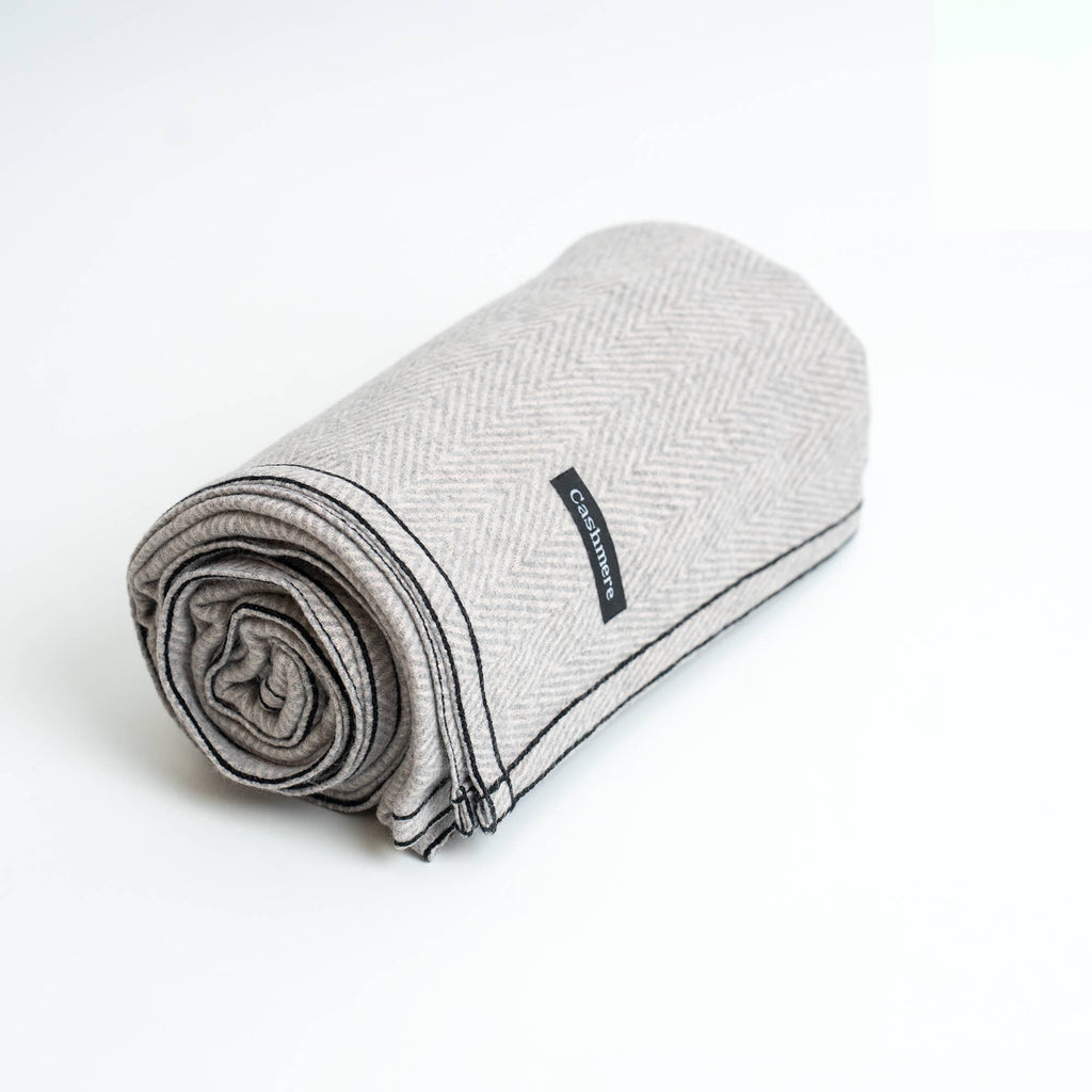 gray cashmere banket rolled on white background