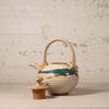 Ceramic teapot with decorative patterns on a textured surface