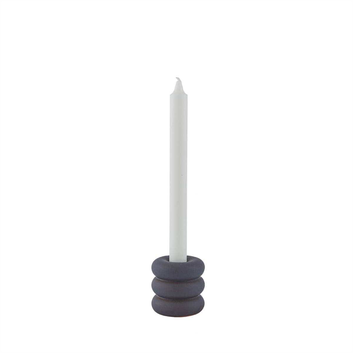 Candle holder with a white candle on a white background