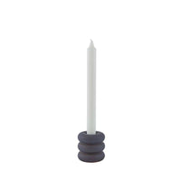 Candle holder with a white candle on a white background