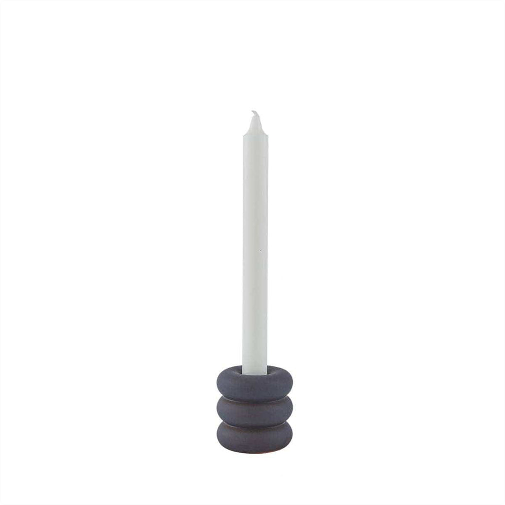 Candle holder with a white candle on a white background