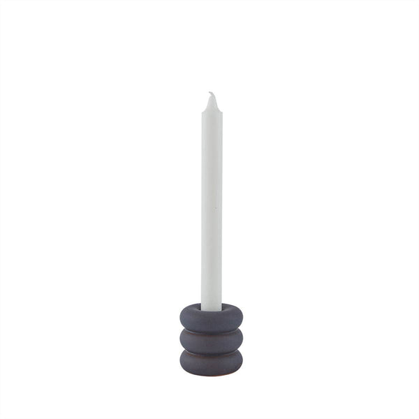 Candle holder with a white candle on a white background