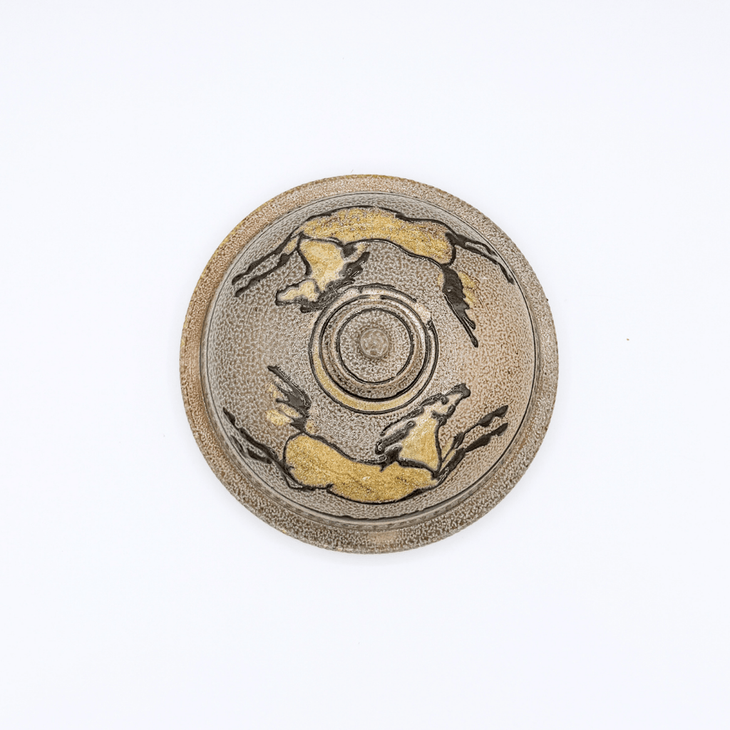 Round ceramic dish with horse illustrations on a white background