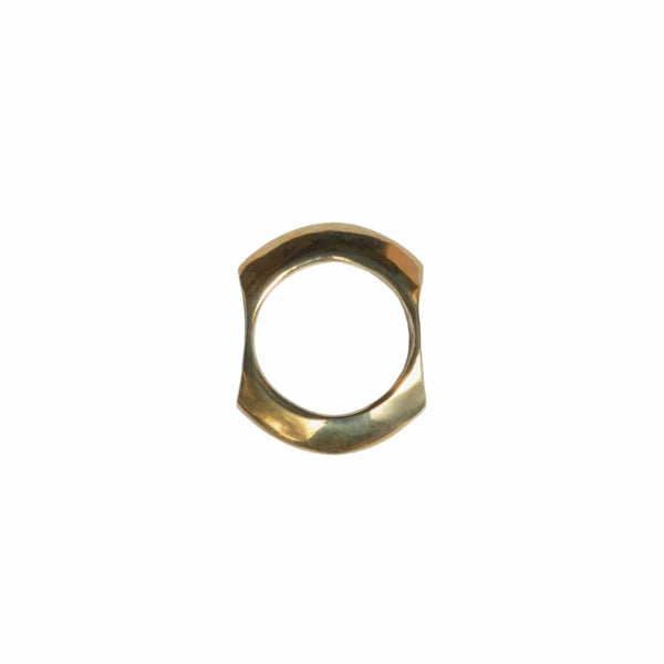 Gold ring with a hexagonal design on a light gray background
