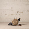 Ceramic teapot with decorative patterns on a textured surface