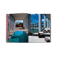 Open book showing images of a modern outdoor setting with a pool and lounge chairs.