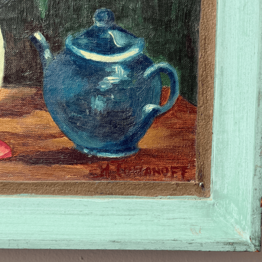 Painting of a blue teapot on a wooden surface with a signature at the bottom right corner.