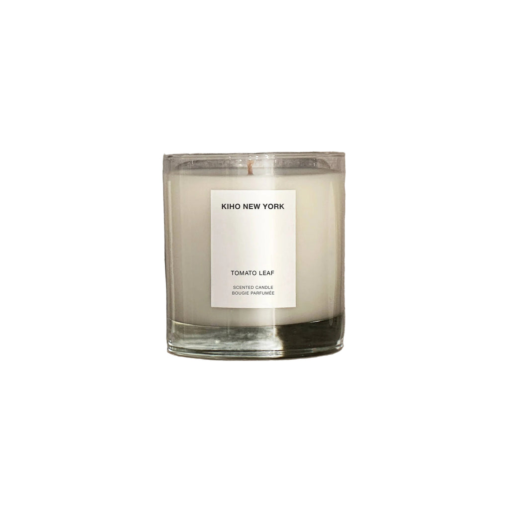 Candle with a label on a concrete surface