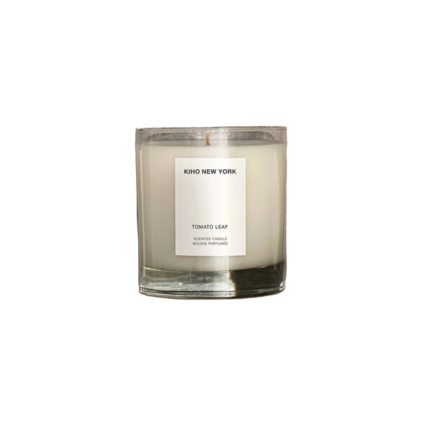 Candle with a label on a concrete surface