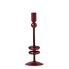 A single tall glass candlestick holder in a deep burgundy red color, featuring a flared base, two stacked circular rings, a bulbous neck, and a cylindrical top cup, shown against a plain white background.