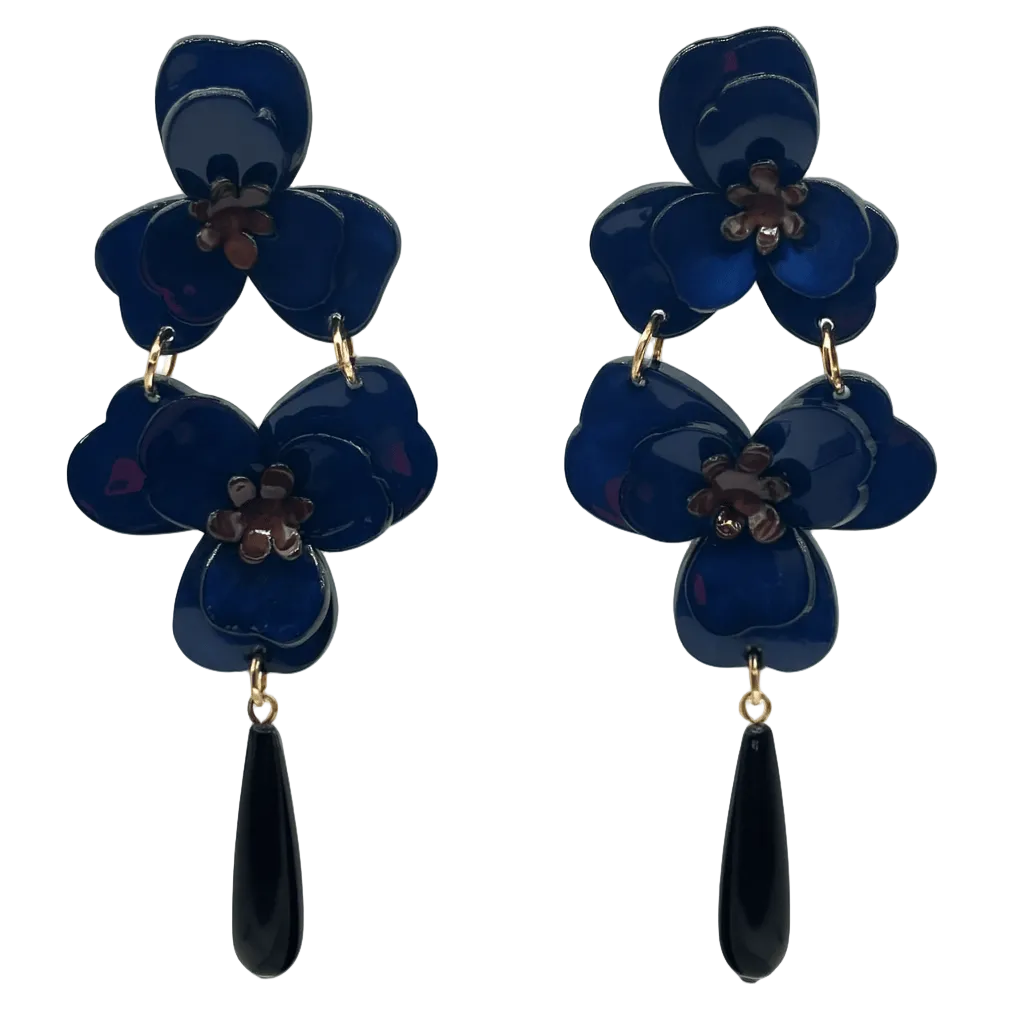Pair of blue flower-shaped earrings with black teardrop pendants on a white background