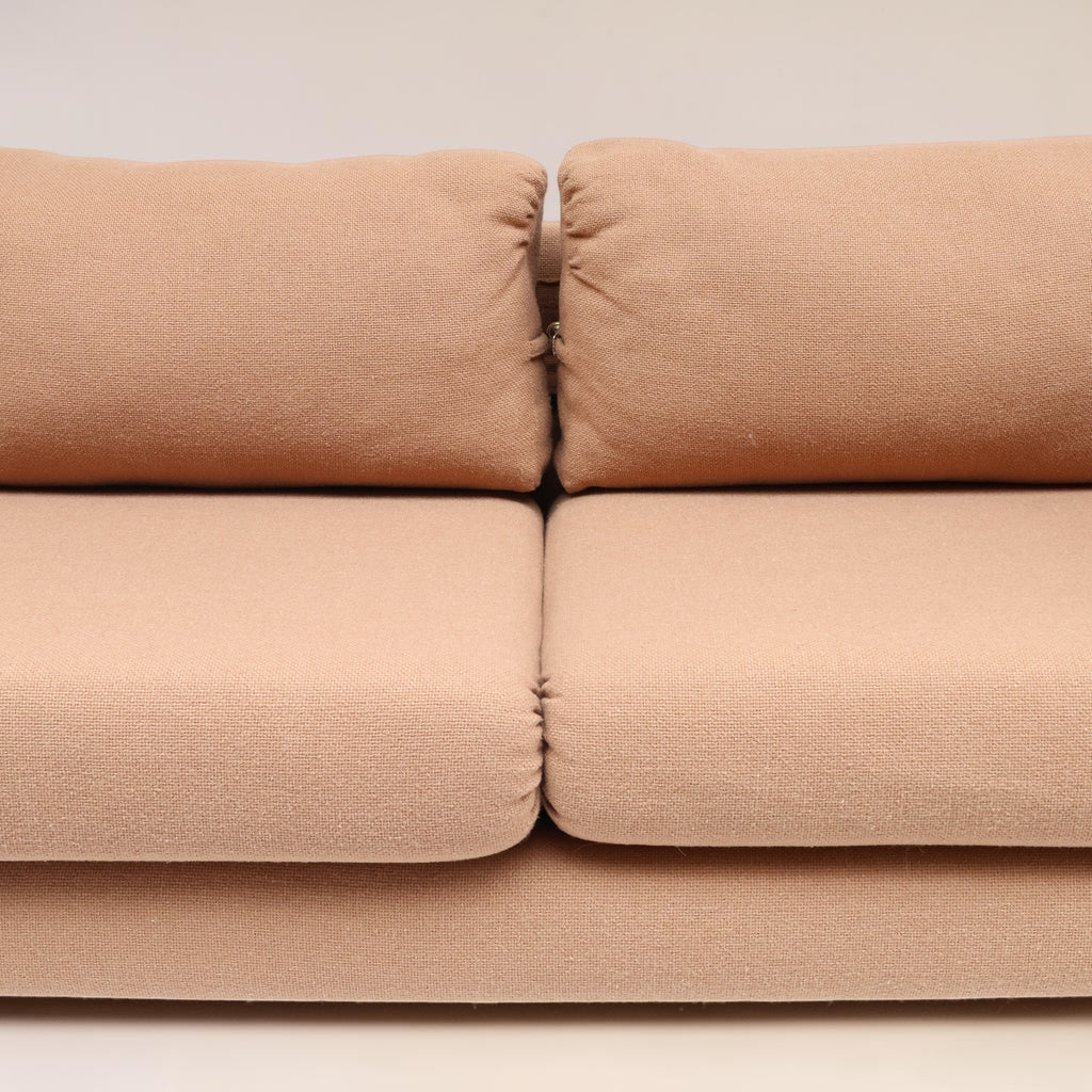 Image features the cushions of a brown mid-century modern wool sofa with a wooden frame against a white background.