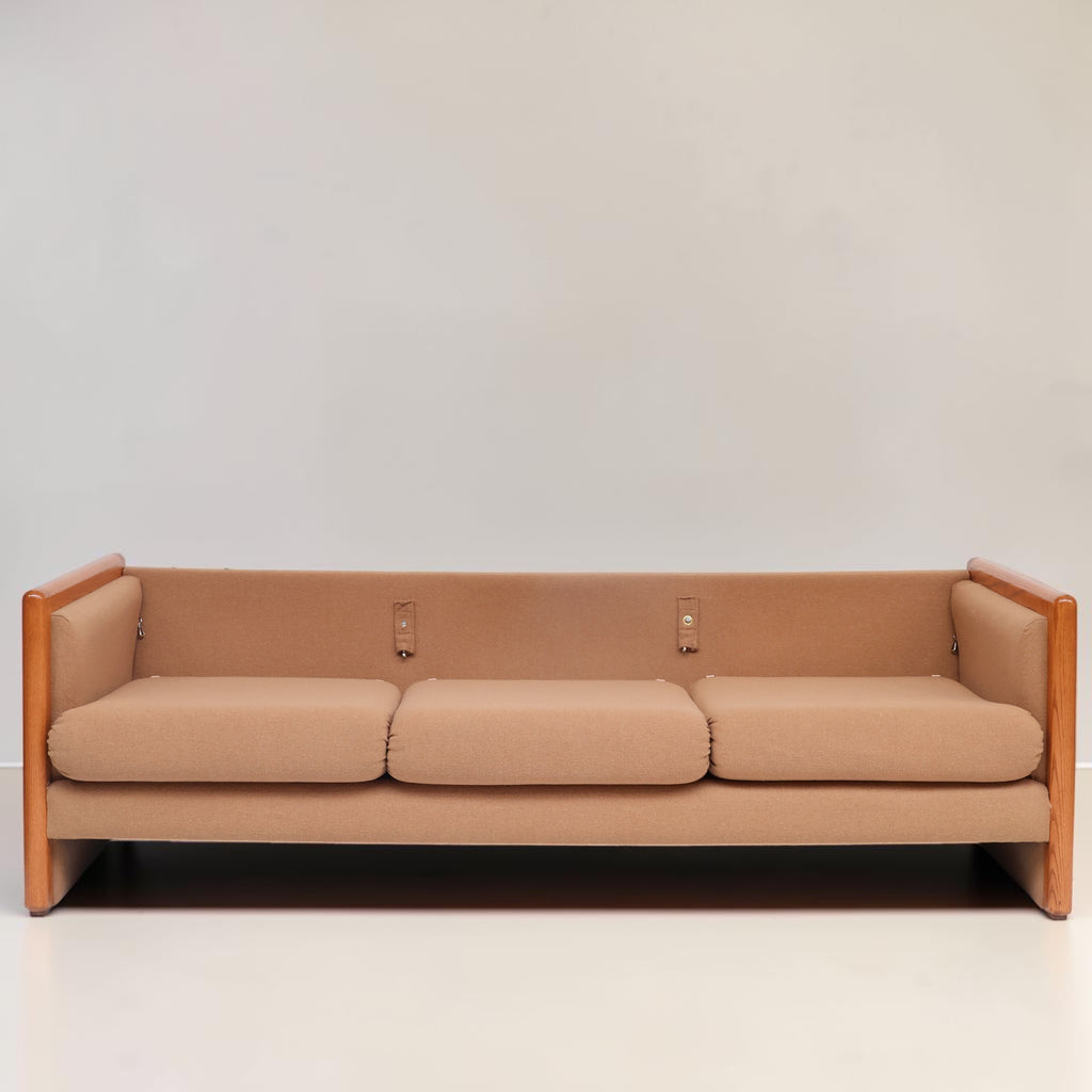 Image features a brown mid-century modern wool sofa with a wooden frame against a white background.