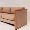 Image features the side of a brown mid-century modern wool sofa with a wooden frame against a white background.