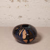 Ceramic vase with abstract design on a neutral background