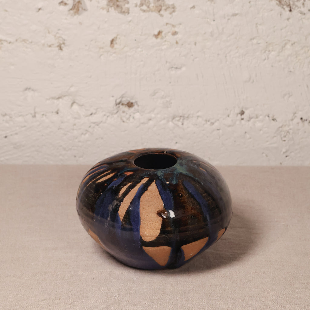Ceramic vase with abstract design on a neutral background