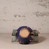 Ceramic dish with blue and brown design on a textured surface