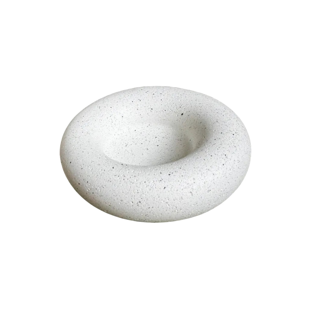 A circular donut-shaped soap dish or tray made of speckled white stone or concrete, shown on a plain white background.