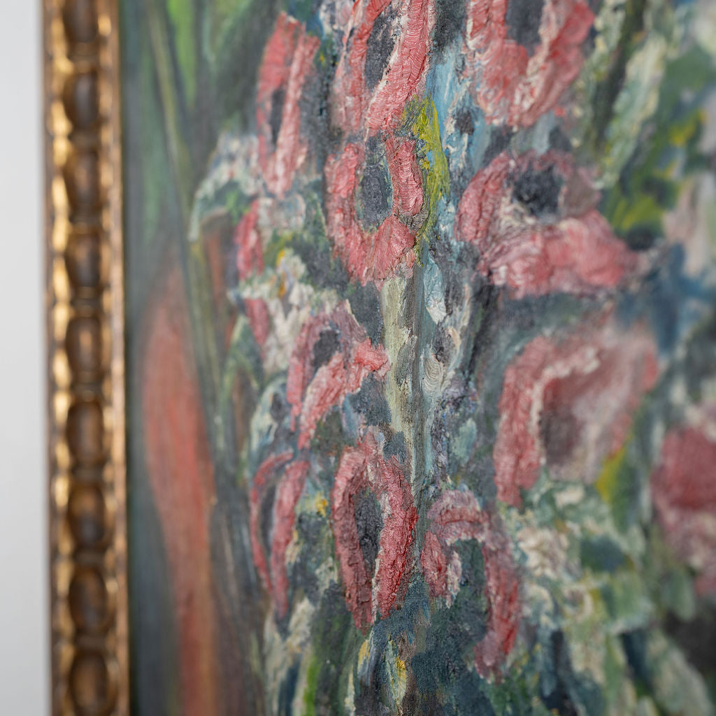 Close-up of a floral painting with pink flowers and green leaves, framed in gold.