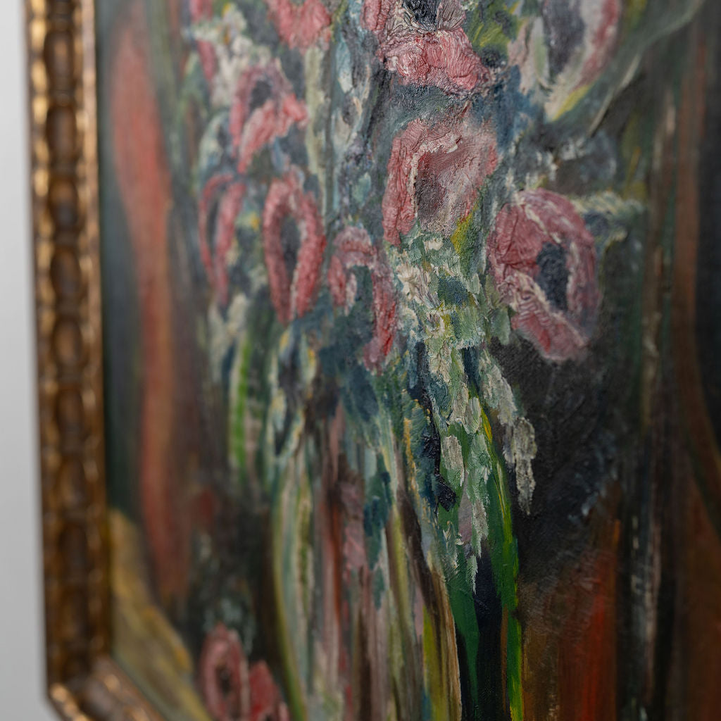Close-up of a floral painting with a gold frame