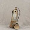 Ceramic vase with a textured surface on a neutral background