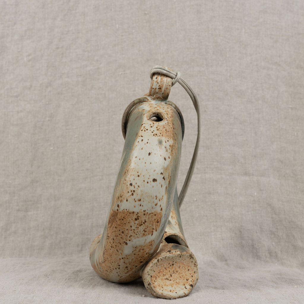 Ceramic vase with a textured surface on a neutral background