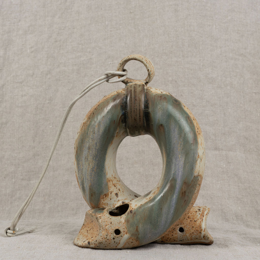 Ceramic ring with rustic finish on a textured gray background