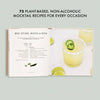 Open book showing a plant-based mocktail recipe with a glass of mocktail and garnishes on a light gray background.