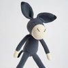 Crocheted donkey toy on a light gray background
