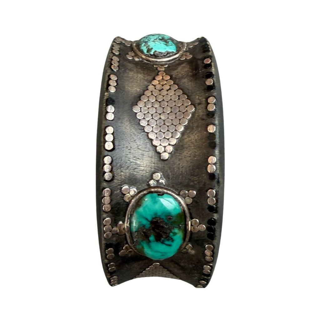 Decorative cuff bracelet with turquoise stones and metallic accents on a white background
